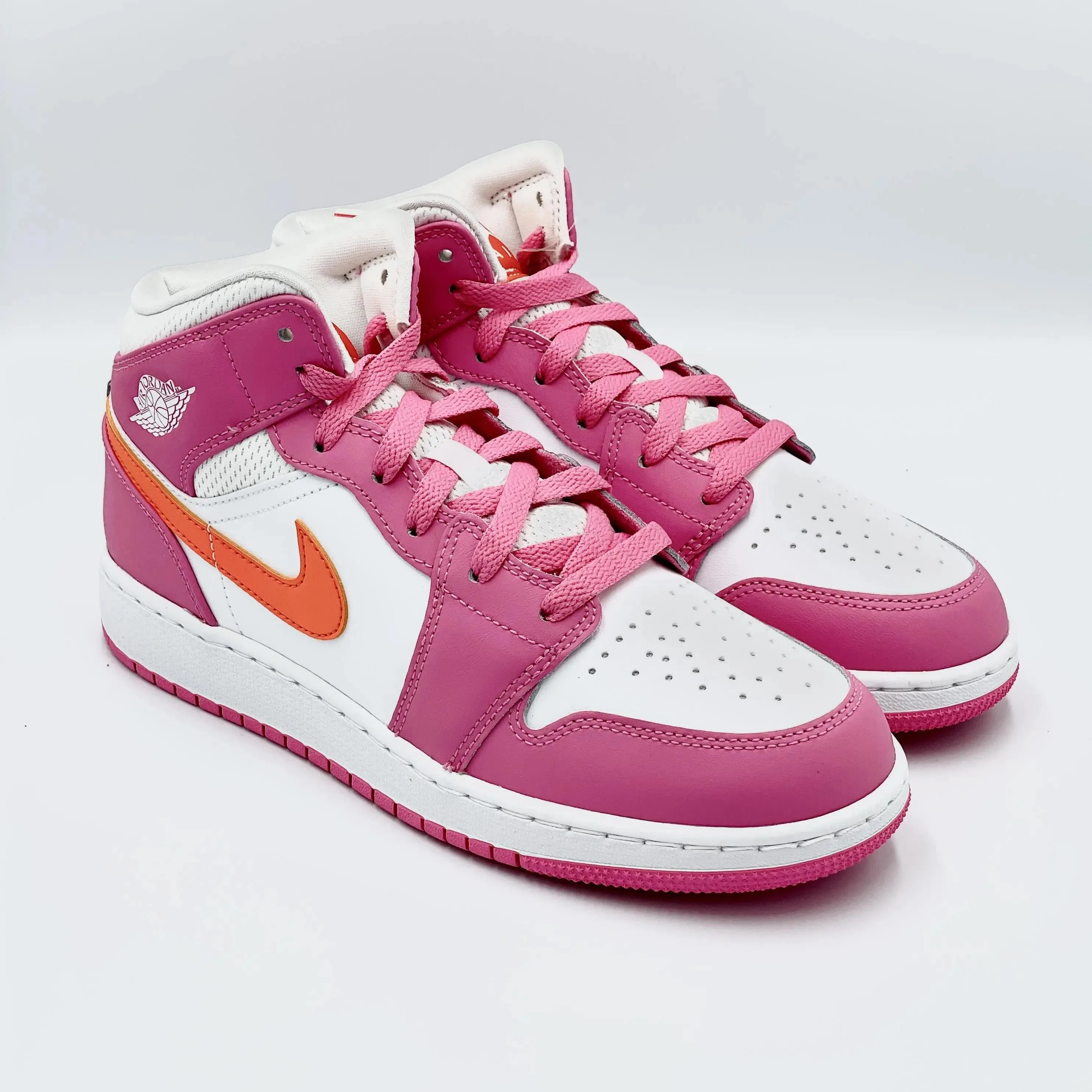 Jordan 1 Mid Pinksicle Safety Orange (GS) sneakers.