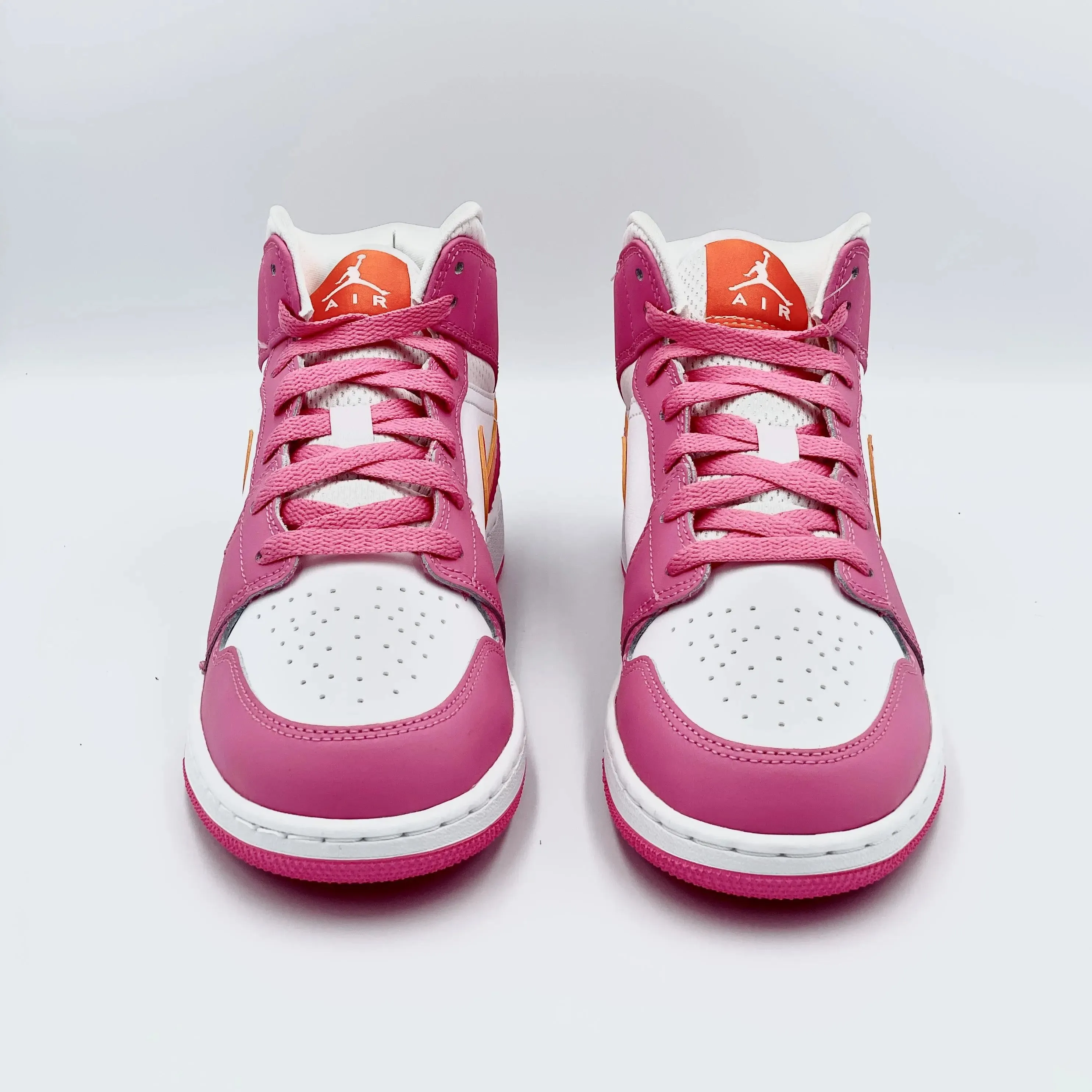 Jordan 1 Mid Pinksicle Safety Orange (GS) sneakers.